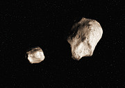 An asteroid that has split due to rotational fission (artist’s impression)