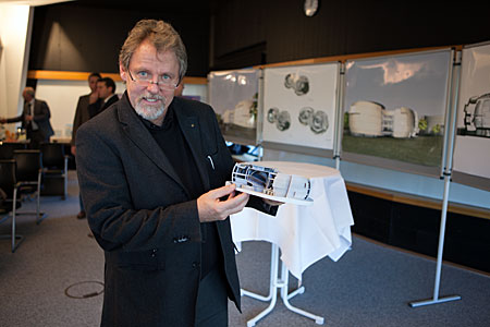 Architect of the Visitor Centre showing a model of the planned building