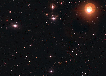 Galaxy ESO 570-19 and Variable Star UW Crateris