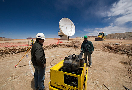 Antenna pad construction work on Chajnantor, in front of an ALMA antenna