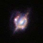 Merging galaxies in the distant Universe through a gravitational magnifying glass