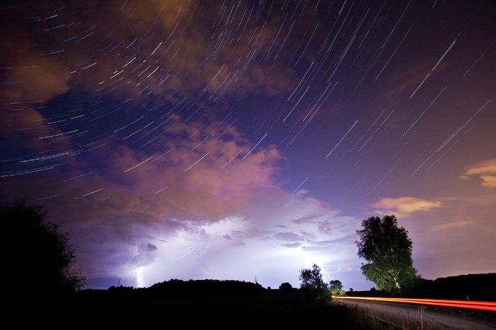 The constellation of Cassiopeia over a thunderstorm