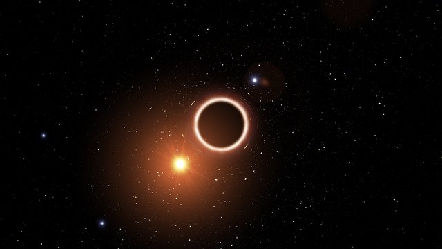 En stjärna passerar ett supertungt svart hål (illustration)